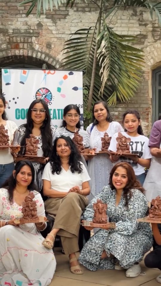 Dipti Shah with participants proudly holding their finished clay Ganesha pieces